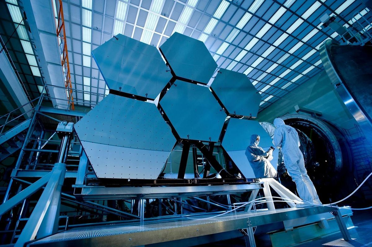 Satellite mirror segments being assembled in a cleanroom facility