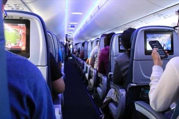 Passengers aboard a commercial aircraft with in-flight entertainment