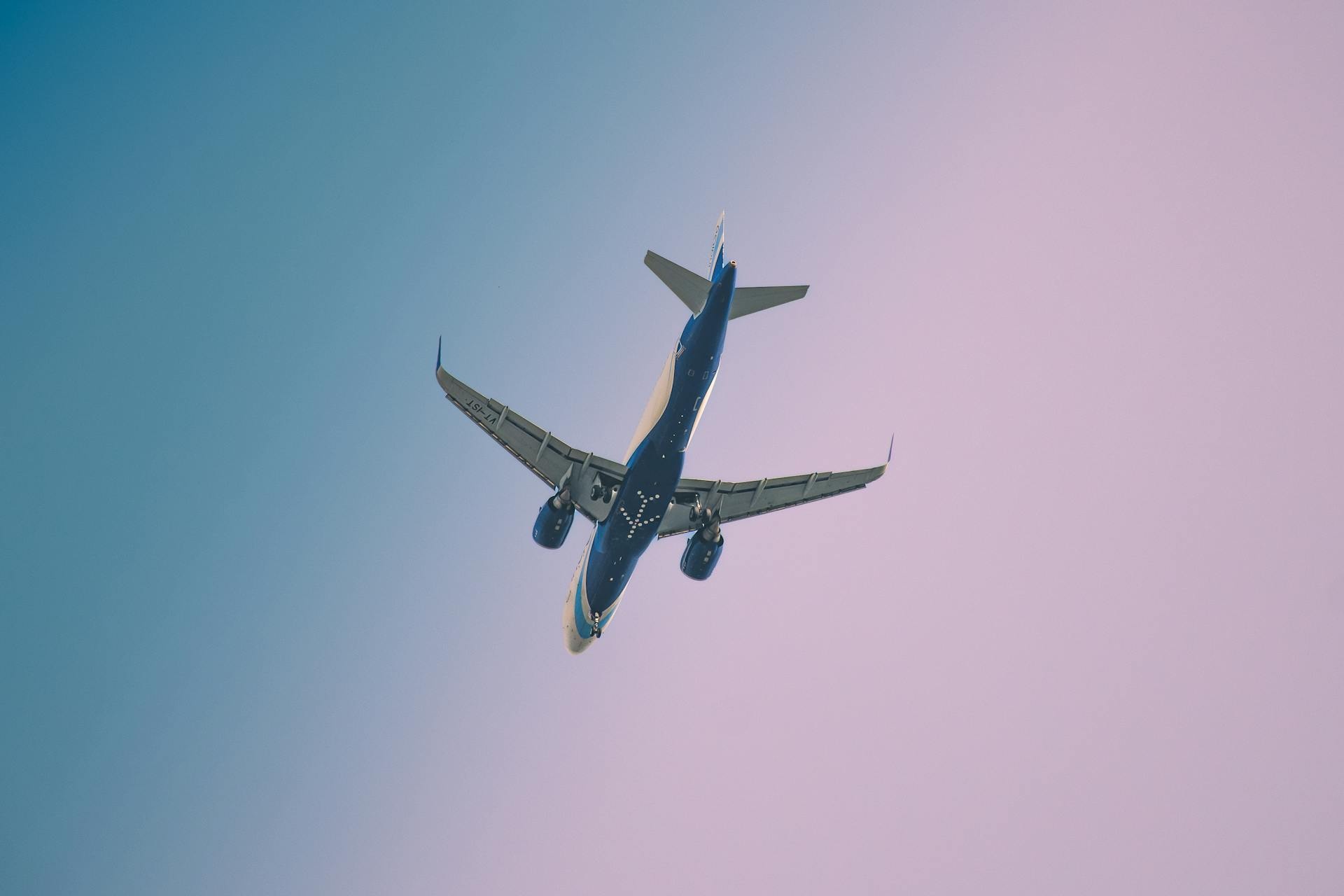 Commercial aircraft on final approach during sunset