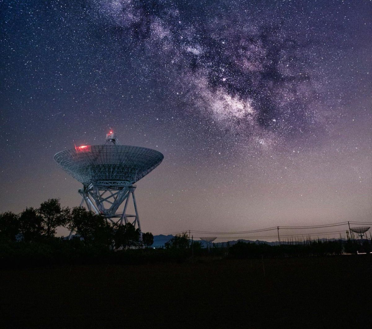 Radio telescope ground station under the Milky Way