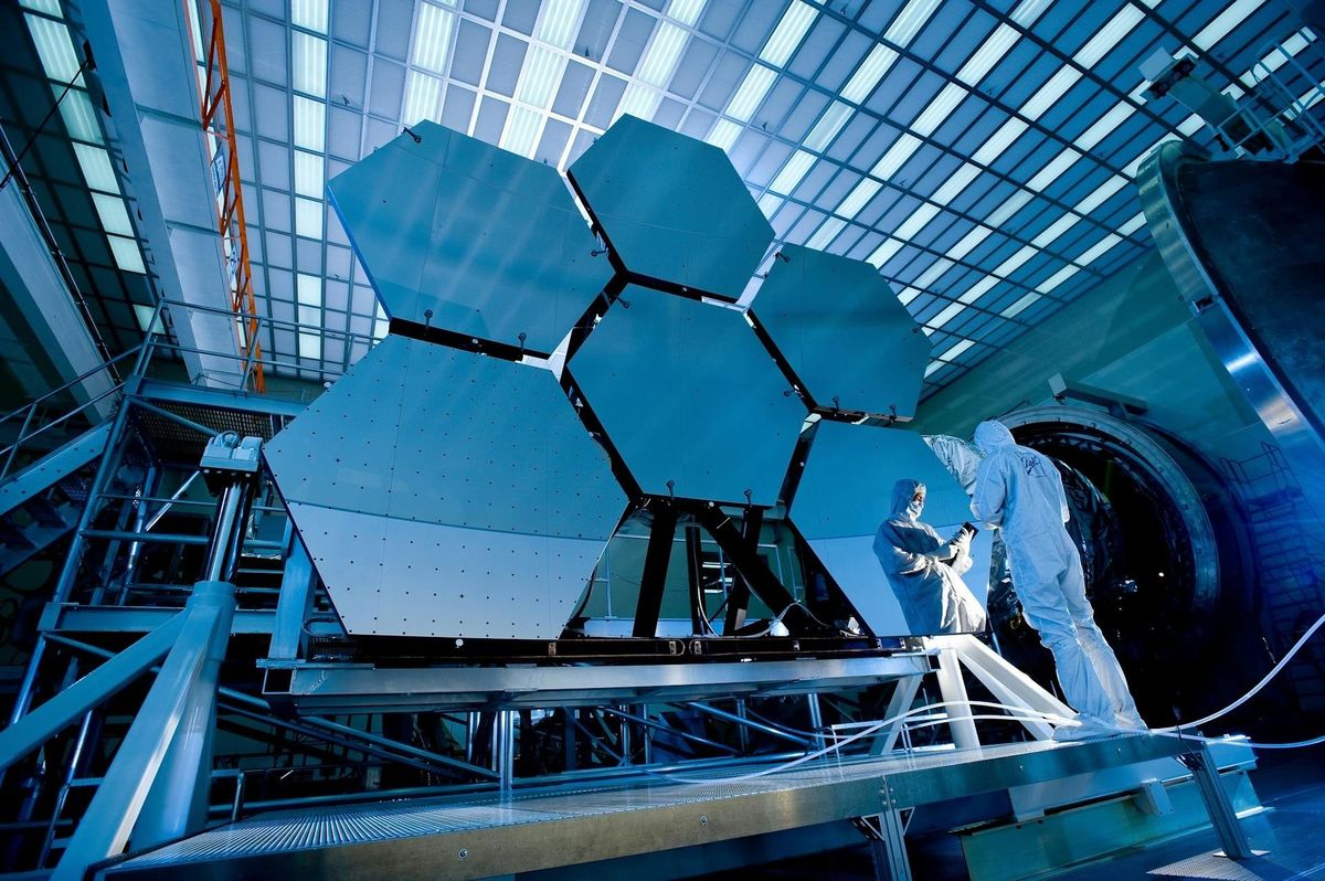 Satellite mirror segments being assembled in a cleanroom facility